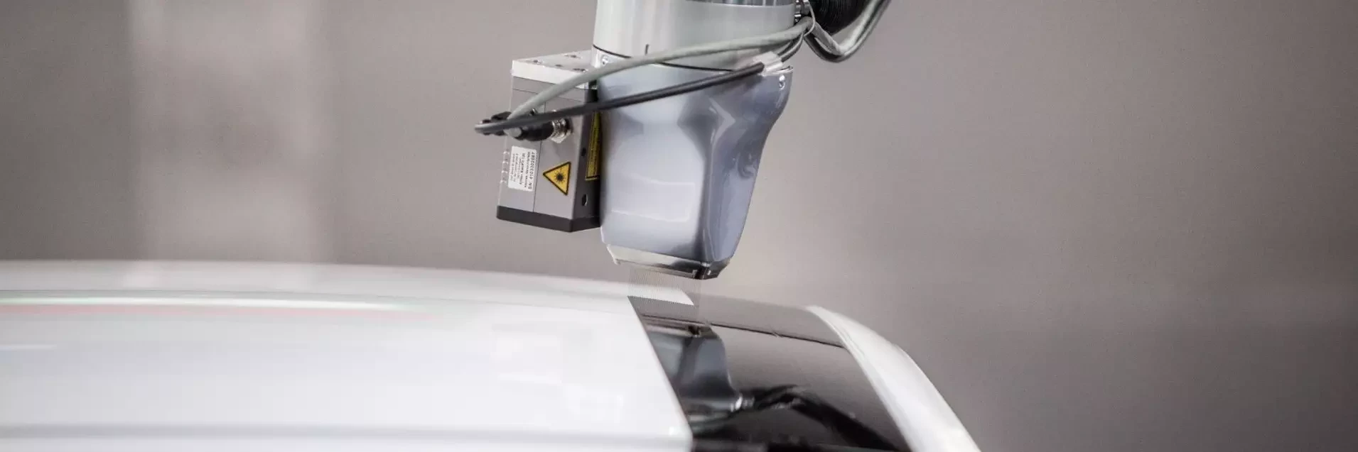 View of EcoPaintjet spraying the surface of a car body